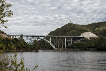 View over the San Roque Dam of Lake San Roque in Córdoba, in the background the bridge 