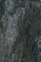 Rock. Background texture of dark stone closeup. Top view, stone from embankment in Poti.