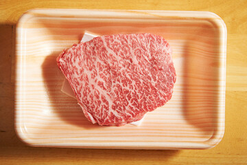 Fresh raw meat on a disposable plate