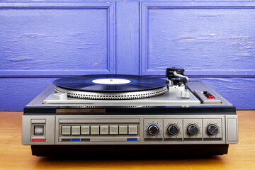 Vintage turntable vinyl record player with black vinyl