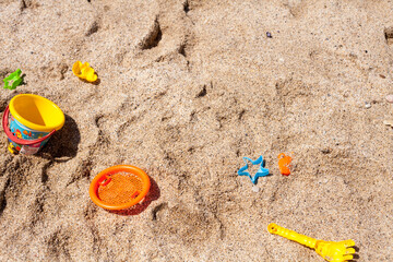 Fototapeta na wymiar Children's beach sand toys. Kids concept. Plastic children's toys. ?olorful molds, shovel and spatulas. Kids toys