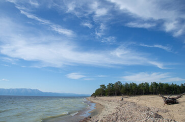 Beautiful blue sky over the sandy beach by the lake.