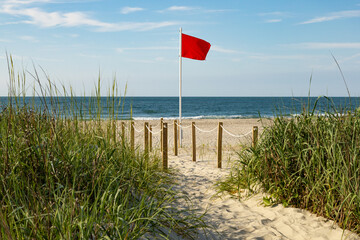 Red flag riptide warning on the beach