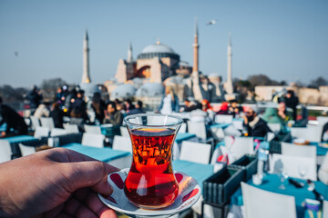 Naklejka premium colorful traditional turkish tea in front of Hagia Sophia Mosque, Istanbul