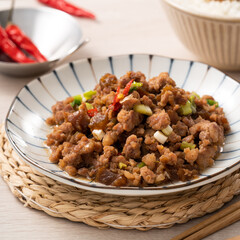 Taiwanese fried minced pork with pickled cucumber on rice named GUA ZI ROU FAN.