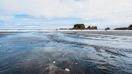 Beautiful view from the shallow sea water of the rock formations on the beach