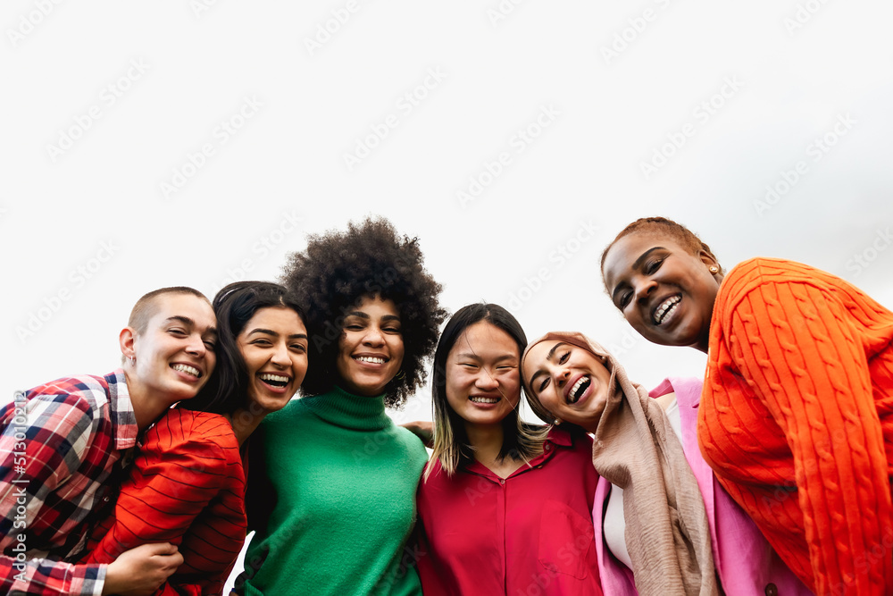 Wall mural Happy young multi ethnic women having fun hanging out in the city