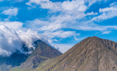 White clouds wrap around the Andes
