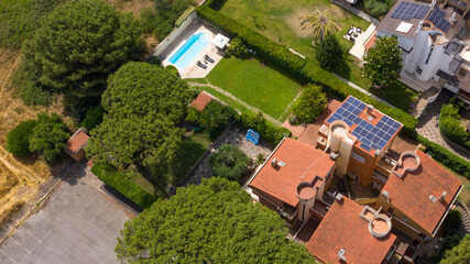 Aerial view on a villa built on one floor with garden and swimming pool.