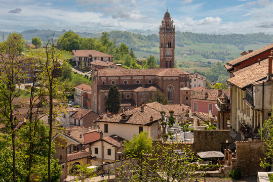 Monforte d'Alba, langhe, Italy: view of medieval village on the Langhe hills with the church Madonna della Neve (Madonna of the snow) on blue sky and white clouds