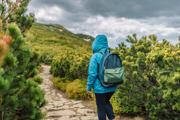 Man and 50s woman hiking on wet rocks at mountain. Babia Gora Poland