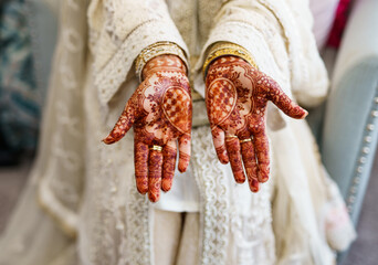 Hands of a female painted with henna