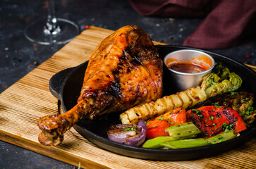 Great fresh baked turkey leg and swith tomato sauce and grilled vegetables in a frying pan....
