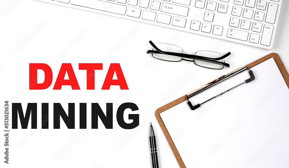 Poster data mining text written on white background with keyboard, paper sheet and pen