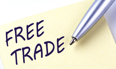 Sticky Note Message FREE TRADE with pen on white background