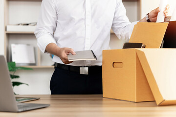Resignation Businessmen are gradually packing personal boxes and resignation letters. Concept of...