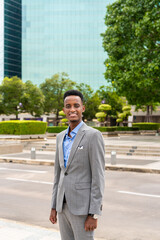 Portrait of handsome young black man outdoors in city