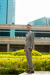 Portrait of handsome young black man outdoors in city