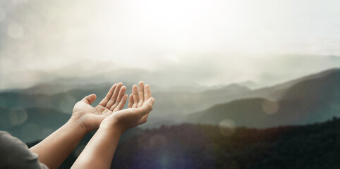 The two hands of a young man who prayed for hope from God Praise God concept. Pray, communicate. Mountain nature background. at sunrise - obrazy, fototapety, plakaty