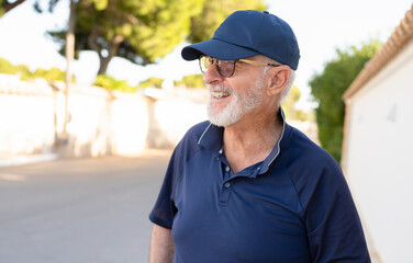 Fototapeta premium Senior grey-haired man smiling happy standing at the city.