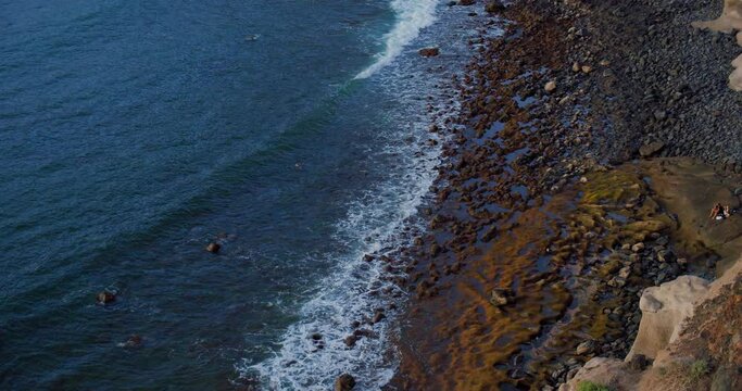 Beautiful sunset reflected on the surface of the Atlantic Ocean. Los Gigantes, Tenerife, Canary islands, Spain. Hend held footage.