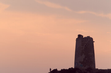 Medieval watchtower with backlight and people