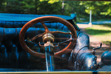 Closeup shot of a steering wheel of an antique car