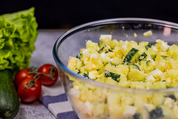 Okroshka - russian national food with meat, potato, kvass or kefir, radish and parsley on white background