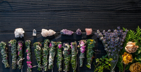 Fototapeta premium Smudge sticks and crystals on a black wooden table