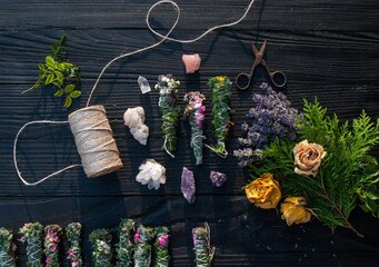 Smudge sticks and crystals on a black wooden table