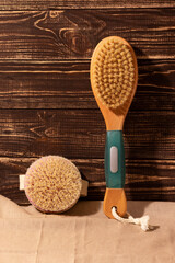 Fototapeta na wymiar Dry massage brushes from natural materials for body care on linen and wooden background