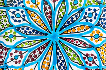 Bright coloured generic Mediterranean style painted pattern on a ceramic surface.