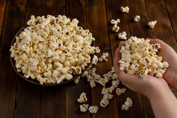 A bowl of delicious popcorn on a wooden table