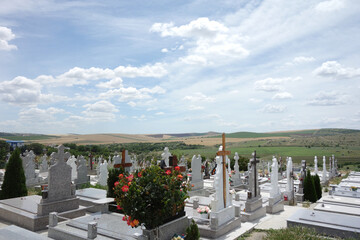 orthodox cemetery in a sunny summer day with orthodox and russian crosses and church