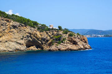 Punta de Sa Cova Blanca peninsula near Santa Eulària des Riu in the southeast of Ibiza island in the Balearic Islands, surmounted by the ruins of an ancient Genoese round tower