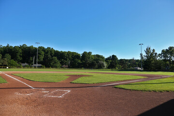 A wide angle view of baseball field shot early in the morning.