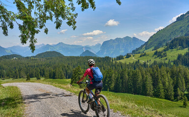 Fototapeta premium nice, active senior woman underway with her electric mountain bike in the Bregenz Wald near Dornbirn, VorarlbergAlps, Austria 