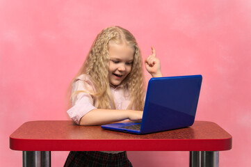 Schoolgirl happy behind the laptop. concept idea.