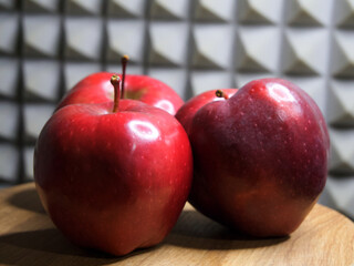 Three apples of the Red Chief variety, close-up. Still life of red apples.