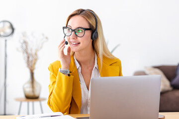 Young woman customer support call center operator or receptionist in headset at workplace, help...