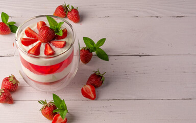 panna cotta dessert with strawberries in a glass bowl