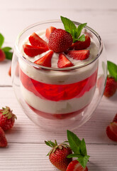 panna cotta dessert with strawberries in a glass bowl