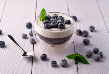 panna cotta dessert with blueberries in a glass bowl