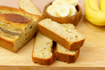 Baked banana bread, sliced on a cutting board. Bakery, cafe, home chef, menu concept