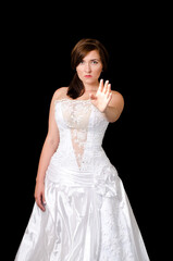 Fototapeta na wymiar A woman in a wedding dress with her hand raised. Stop the wedding.