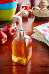 A glass of healthy fresh apple juice isolated on wooden background side view