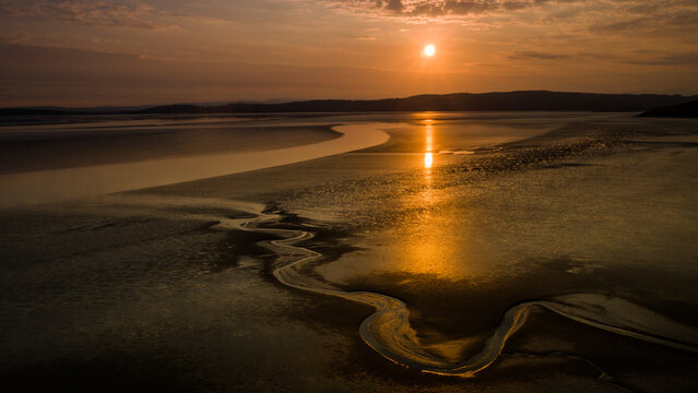 A drone aerial shot of the sunset over Silverdale Morecambe Bay which is notorious for quicksand