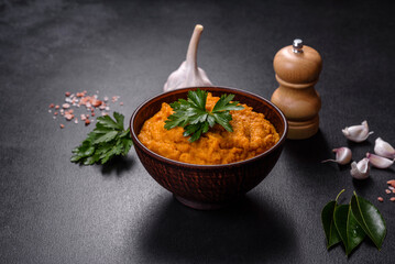 Squash caviar with garlic and tomatoes in a rustic bowl on a dark background