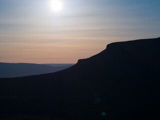 Sunsets of the distinct silhouette of Penyghent one of three hills that make up the Yorkshire 3 Peaks