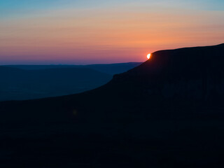 Sunsets of the distinct silhouette of Penyghent one of three hills that make up the Yorkshire 3 Peaks